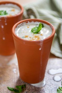 "A glass of refreshing mint lassi garnished with fresh mint leaves."