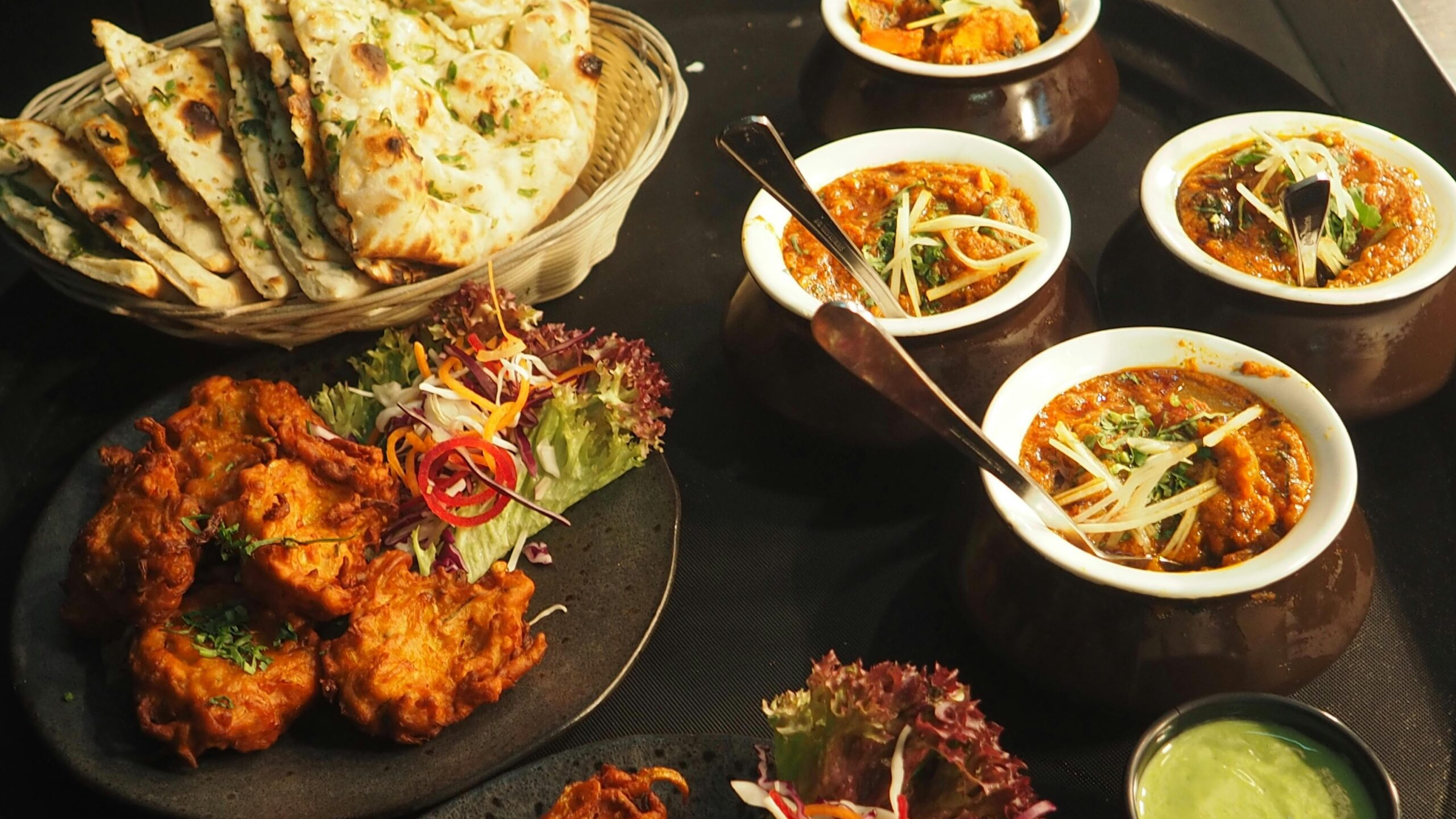 "A plate of delicious chicken curry served with soft roti bread."